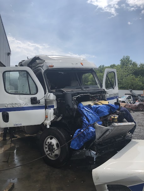 Mobile Truck Repair - Technician Working on Truck with Opened Hood"